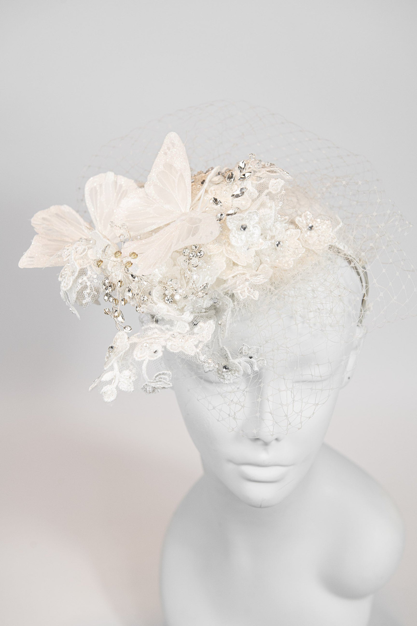 Ivory floral fascinator with large butterflies and crystal embellishments