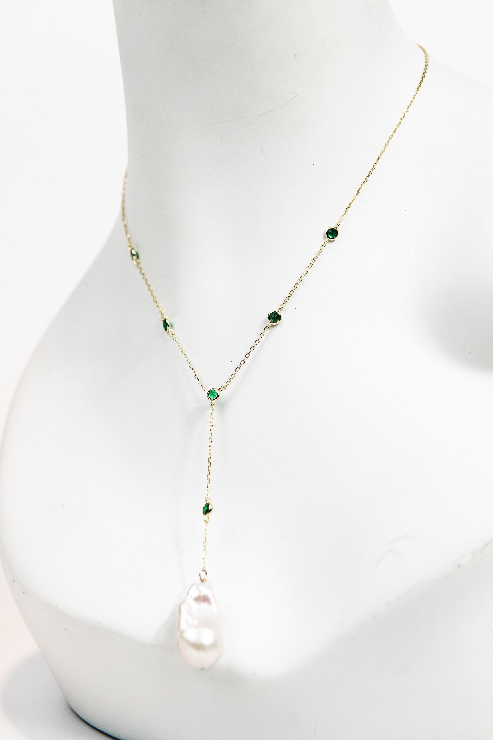 Baroque pearl lariat necklace with emerald crystal detail and gold chain