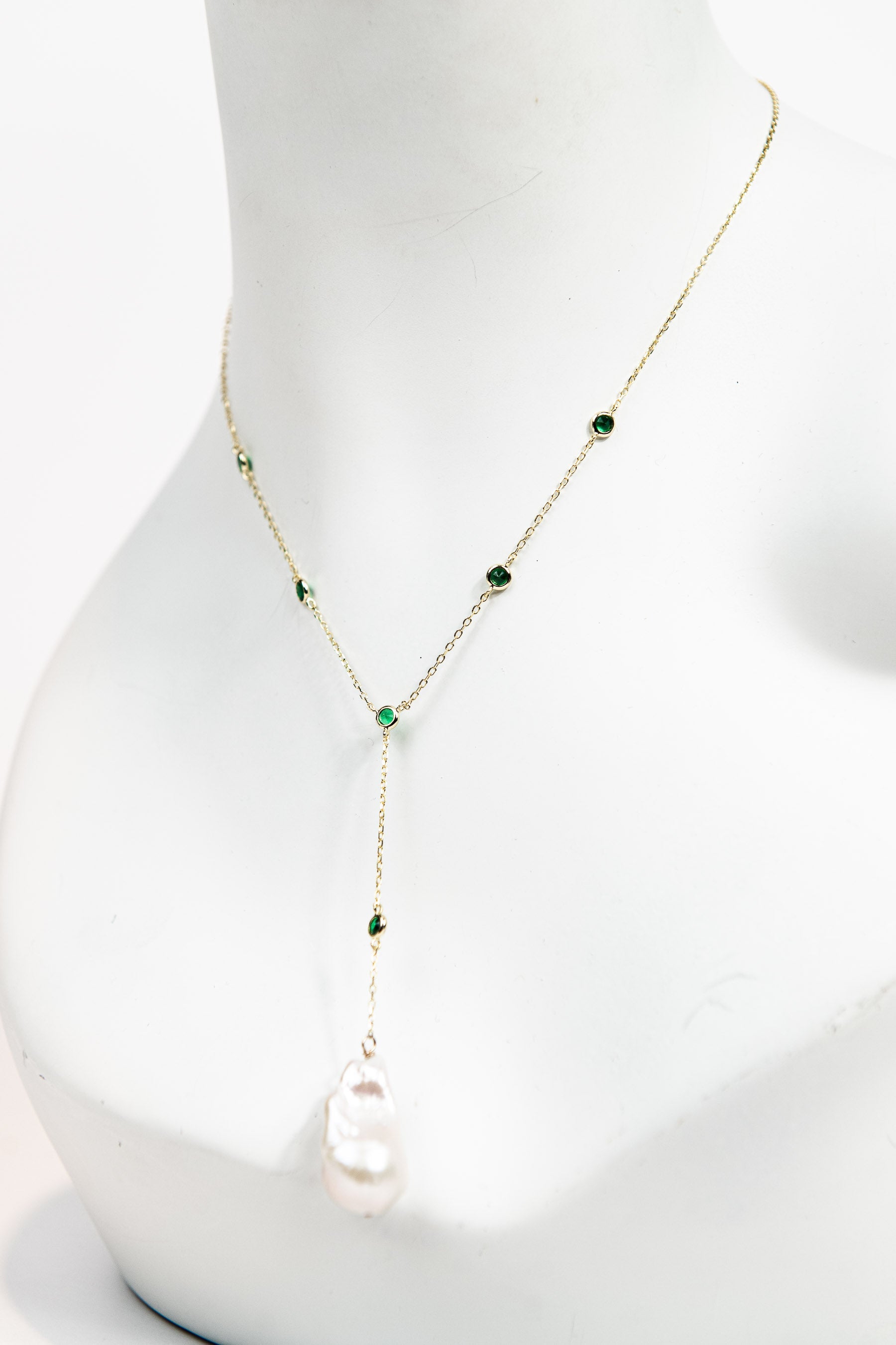 Baroque pearl lariat necklace with emerald crystal detail and gold chain