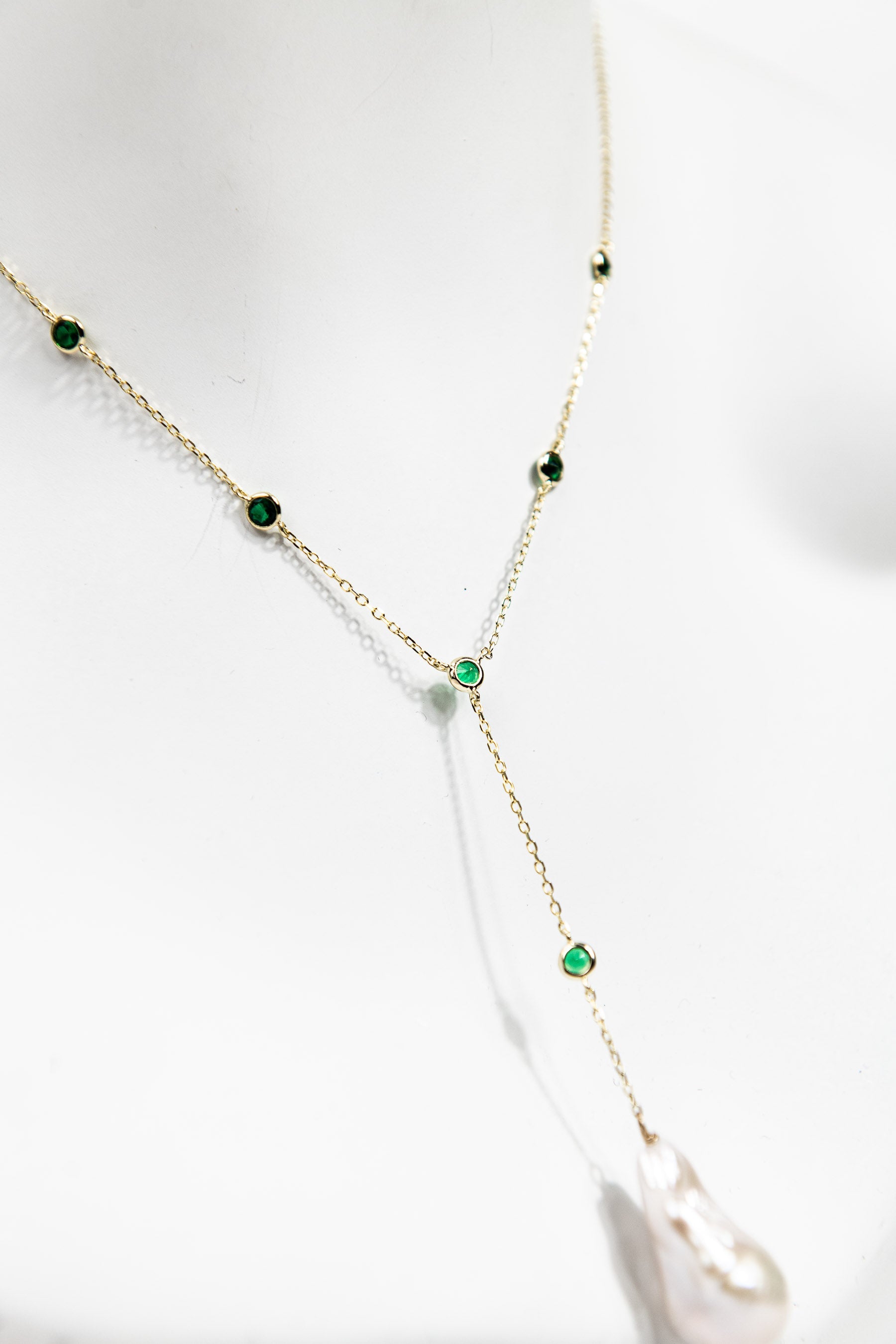 Baroque pearl lariat necklace with emerald crystal detail and gold chain