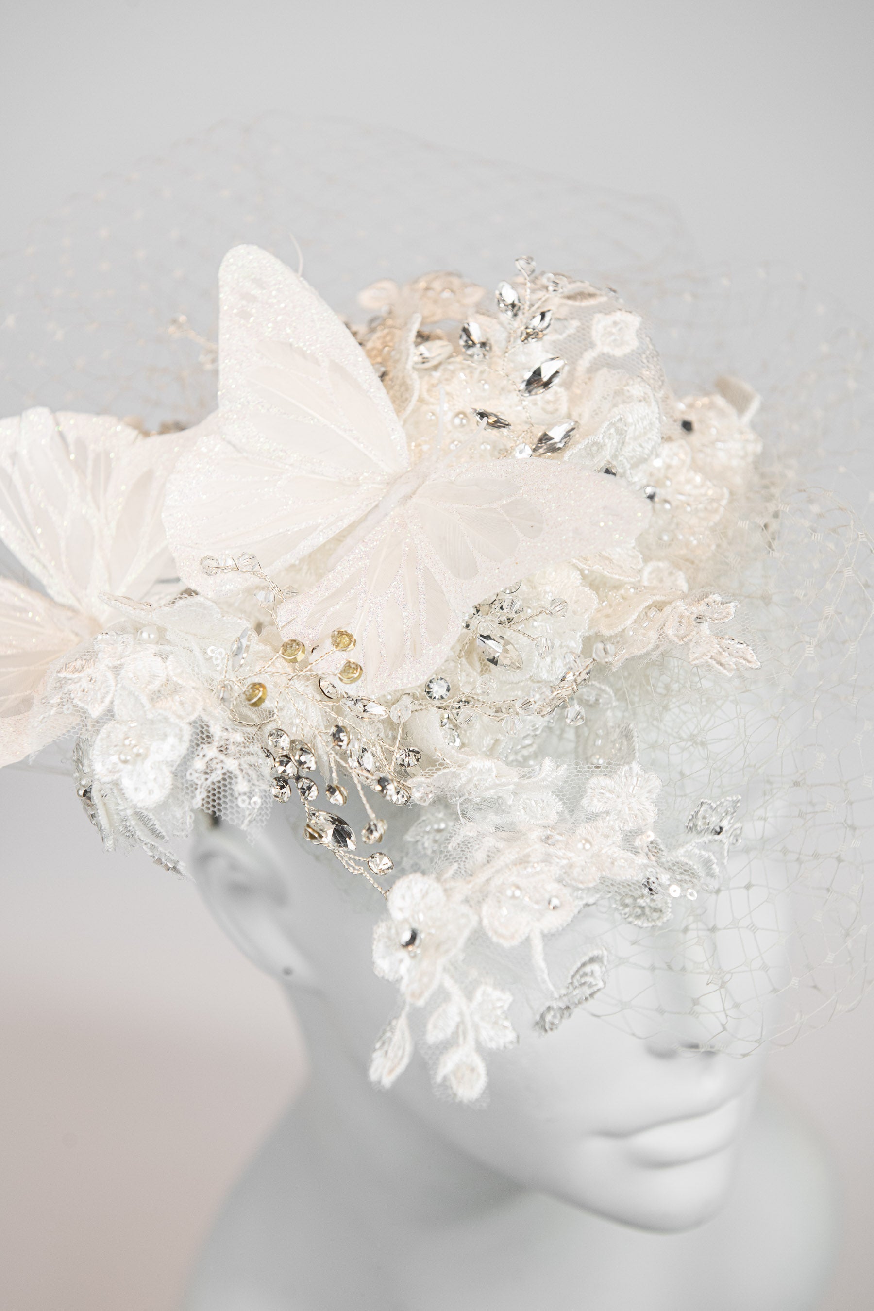 Ivory floral fascinator with large butterflies and crystal embellishments